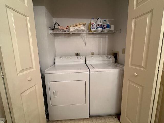 clothes washing area with laundry area and washer and dryer