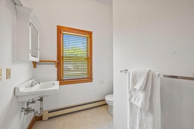 bathroom with baseboard heating and toilet