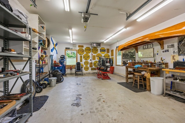 garage featuring a garage door opener and a workshop area