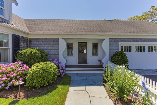 30 Tisquantum Rd, Chatham, MA 02633 - doorway to property featuring a shingled roof, a garage, and covered porch