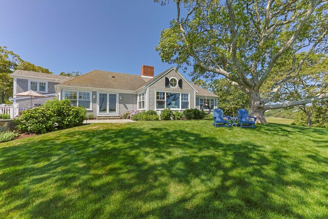 30 Tisquantum Rd, Chatham, MA 02633 - rear view of house with a chimney, entry steps, and a lawn
