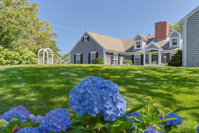 30 Tisquantum Rd, Chatham, MA 02633 - view of front of house with a chimney and a front lawn