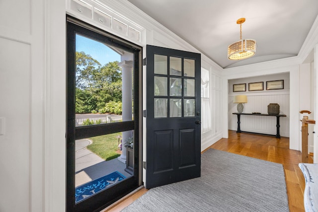 30 Tisquantum Rd, Chatham, MA 02633 - entryway featuring vaulted ceiling, wood finished floors, and crown molding