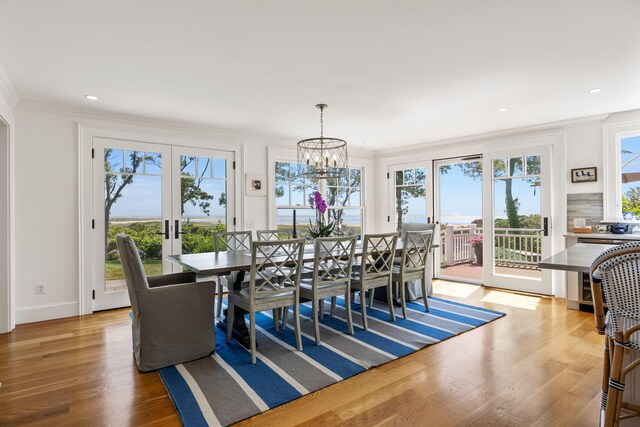 30 Tisquantum Rd, Chatham, MA 02633 - dining space with light wood-type flooring, plenty of natural light, crown molding, a chandelier, and french doors