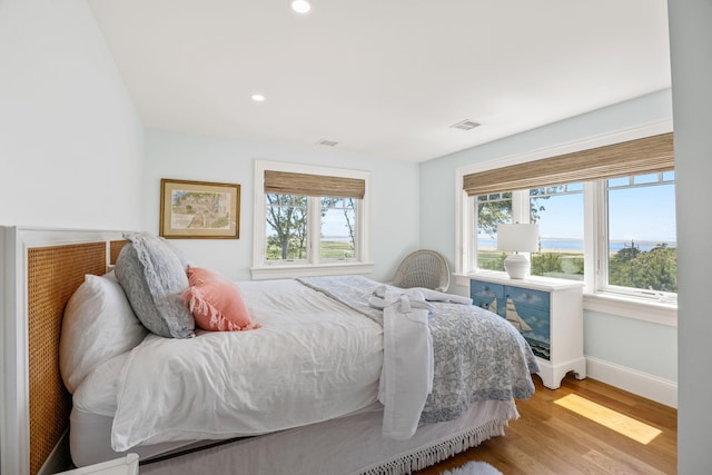 30 Tisquantum Rd, Chatham, MA 02633 - bedroom featuring multiple windows, light wood-type flooring, a water view, and recessed lighting