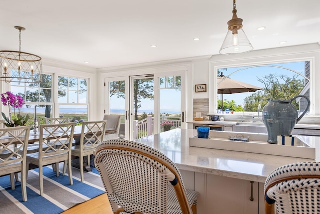 30 Tisquantum Rd, Chatham, MA 02633 - dining space featuring healthy amount of natural light, crown molding, wood finished floors, a chandelier, and recessed lighting