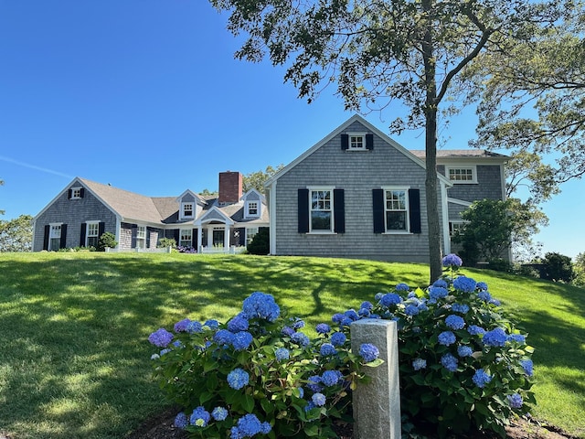 30 Tisquantum Rd, Chatham, MA 02633 - rear view of property featuring a lawn and a chimney