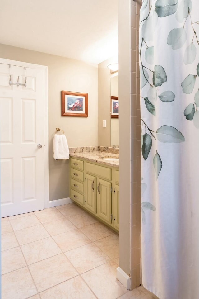 bathroom featuring baseboards, curtained shower, vanity, and tile patterned floors