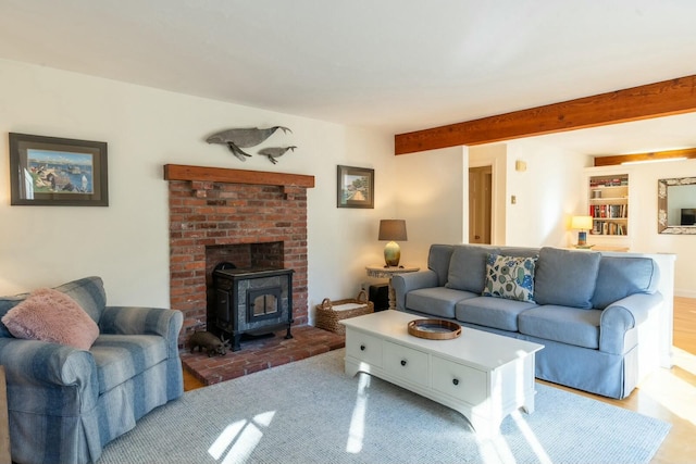 living area featuring a wood stove and beam ceiling
