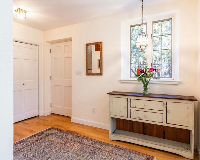hallway with baseboards and wood finished floors