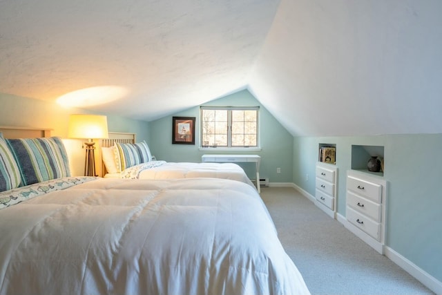 bedroom featuring light carpet, a baseboard radiator, lofted ceiling, and baseboards
