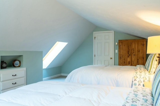bedroom featuring vaulted ceiling and baseboards