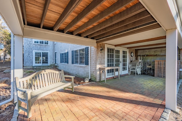 wooden terrace with a patio area