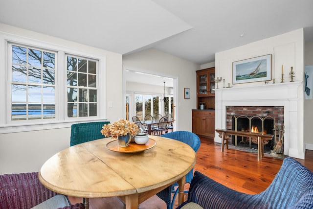 dining area featuring wood finished floors and a fireplace