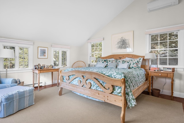 bedroom with wood finished floors, baseboards, a wall unit AC, and vaulted ceiling