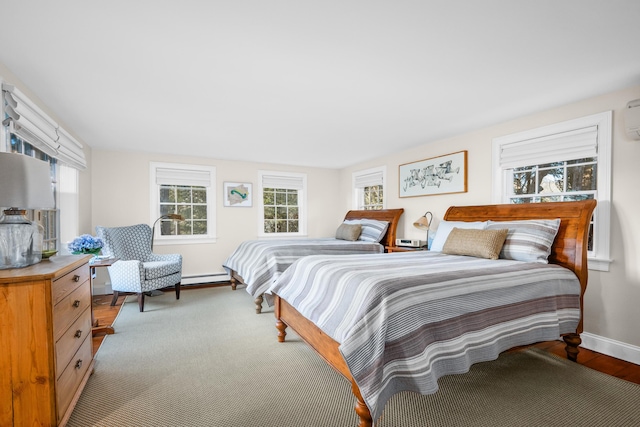 bedroom featuring a baseboard heating unit and baseboards