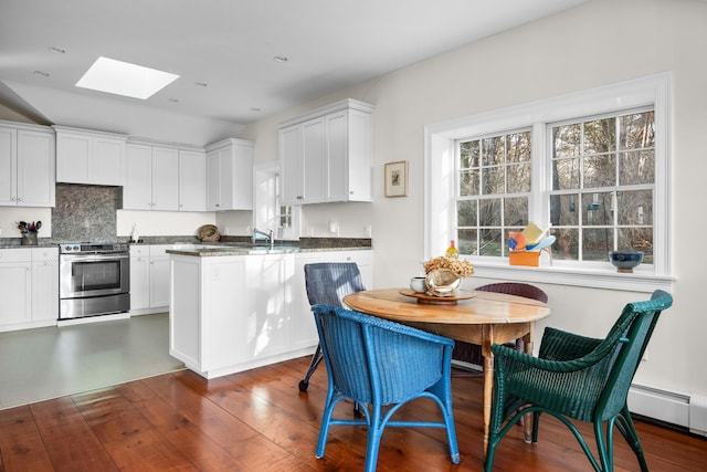 kitchen featuring electric range, dark wood-style floors, and white cabinets