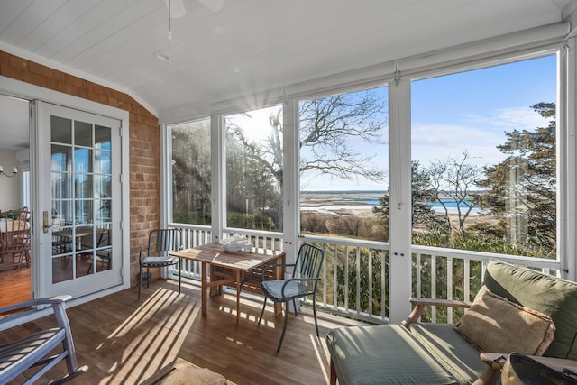 sunroom / solarium featuring lofted ceiling