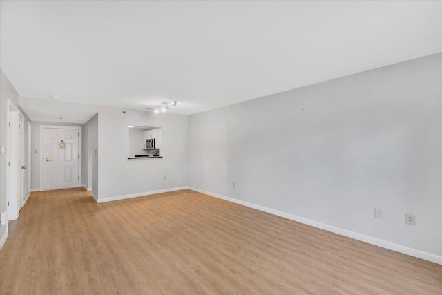 2124 Heatherwood, Yarmouth Port, MA 02675 - unfurnished living room featuring light wood finished floors and baseboards