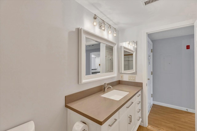 2124 Heatherwood, Yarmouth Port, MA 02675 - bathroom featuring vanity, toilet, baseboards, and wood finished floors