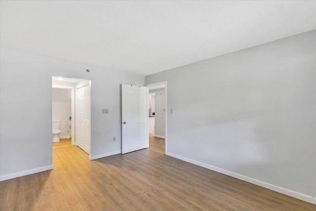 2124 Heatherwood, Yarmouth Port, MA 02675 - unfurnished bedroom featuring baseboards, light wood finished floors, and ensuite bathroom