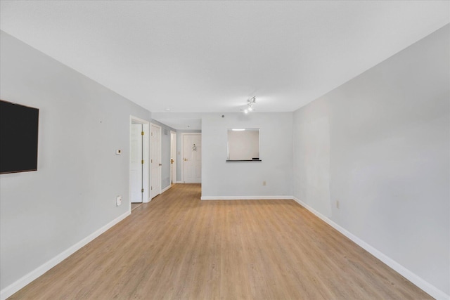 2124 Heatherwood, Yarmouth Port, MA 02675 - unfurnished living room featuring light wood finished floors and baseboards