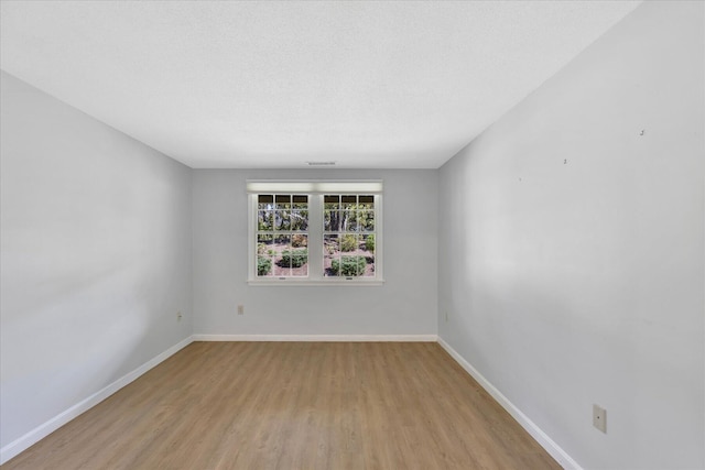 2124 Heatherwood, Yarmouth Port, MA 02675 - empty room with wood finished floors, baseboards, and a textured ceiling