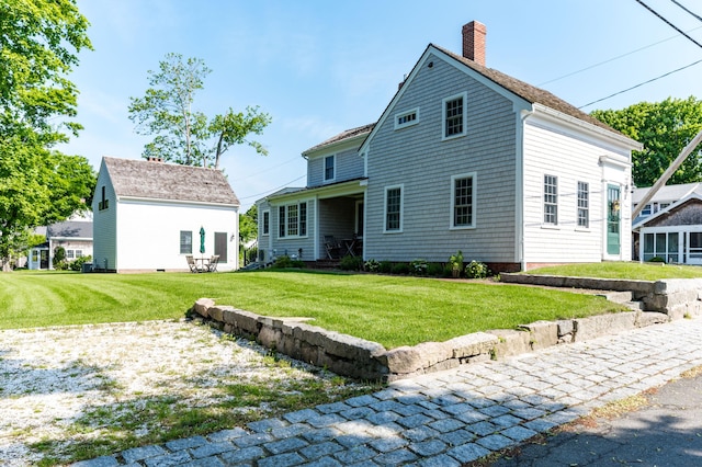 back of property featuring a lawn