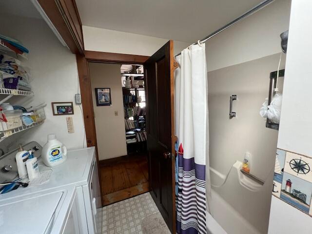 interior space featuring light floors and washer and dryer
