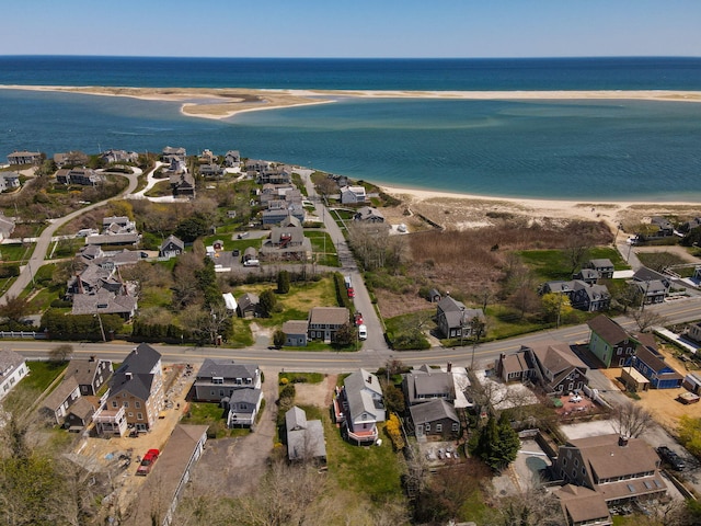 aerial view featuring a water view, a view of the beach, and a residential view