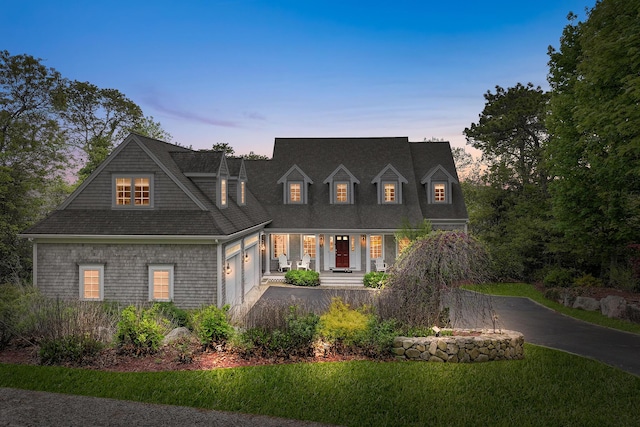 38 Captain Baker Rd, Brewster, MA 02631 - shingle-style home with a porch, a garage, driveway, and a lawn