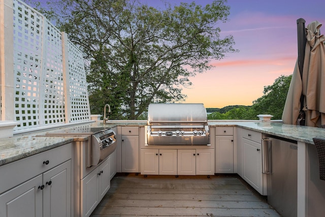 38 Captain Baker Rd, Brewster, MA 02631 - patio terrace at dusk with a wooden deck