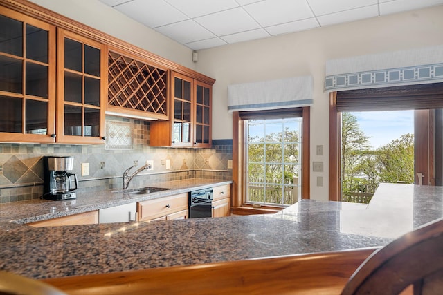 38 Captain Baker Rd, Brewster, MA 02631 - kitchen featuring a sink, plenty of natural light, backsplash, and glass insert cabinets