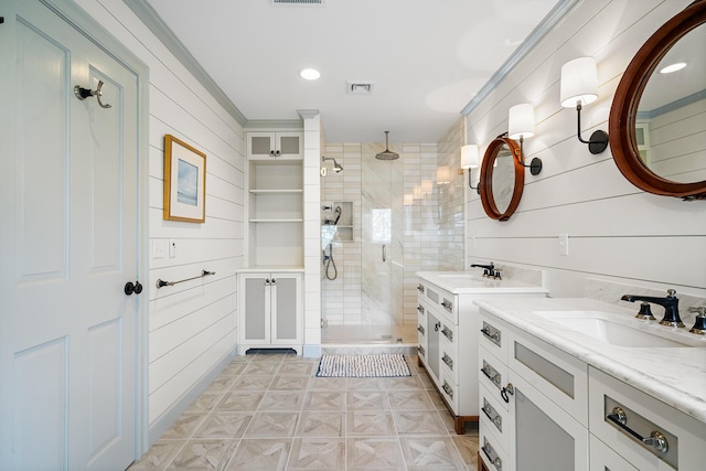 38 Captain Baker Rd, Brewster, MA 02631 - bathroom with a stall shower, two vanities, crown molding, and recessed lighting