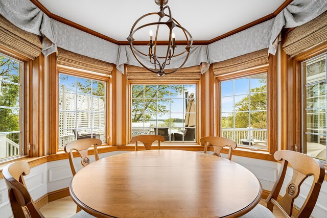 38 Captain Baker Rd, Brewster, MA 02631 - dining area with a chandelier, a decorative wall, ornamental molding, and wainscoting