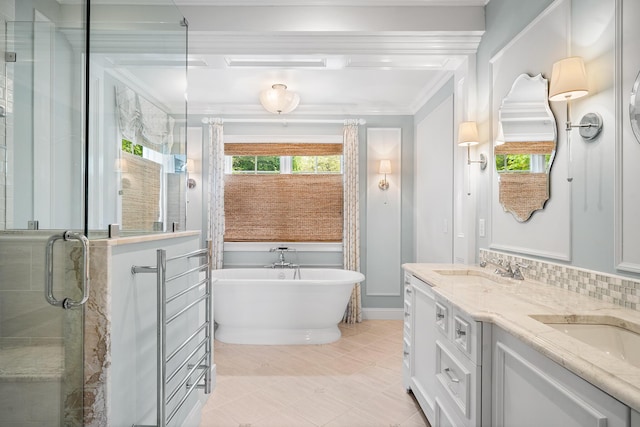 38 Captain Baker Rd, Brewster, MA 02631 - bathroom featuring double vanity, a freestanding tub, a shower stall, crown molding, and decorative backsplash