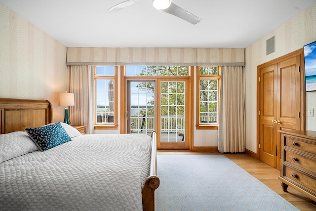 38 Captain Baker Rd, Brewster, MA 02631 - bedroom with wallpapered walls, access to exterior, light wood finished floors, a ceiling fan, and baseboards