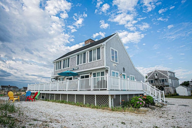 back of property featuring a wooden deck