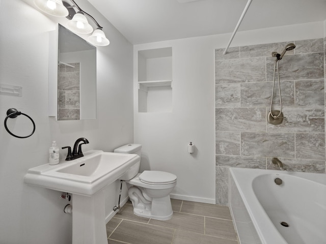 bathroom featuring tiled shower / bath combo and toilet