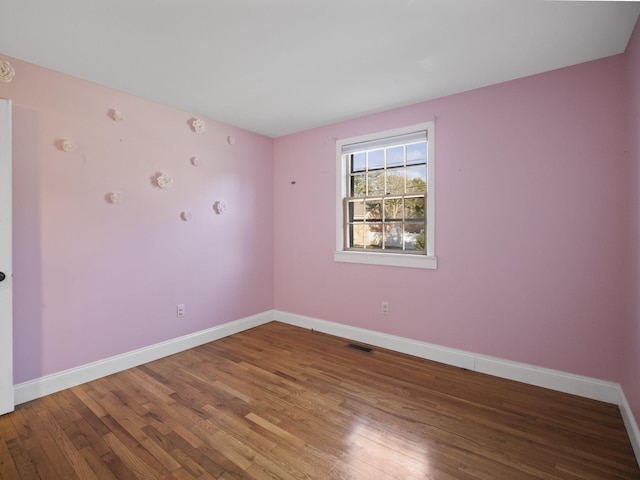 unfurnished room featuring hardwood / wood-style flooring