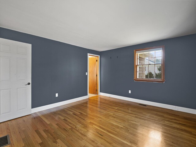 unfurnished bedroom with hardwood / wood-style flooring