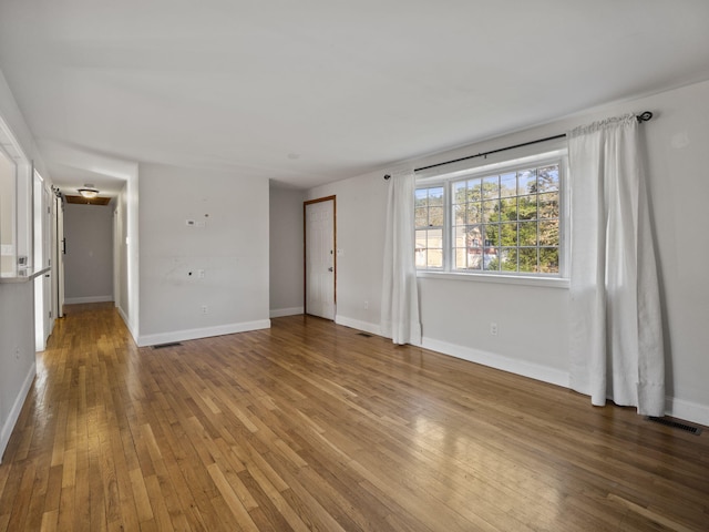 unfurnished room featuring hardwood / wood-style floors