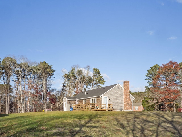 view of property exterior featuring a deck and a lawn