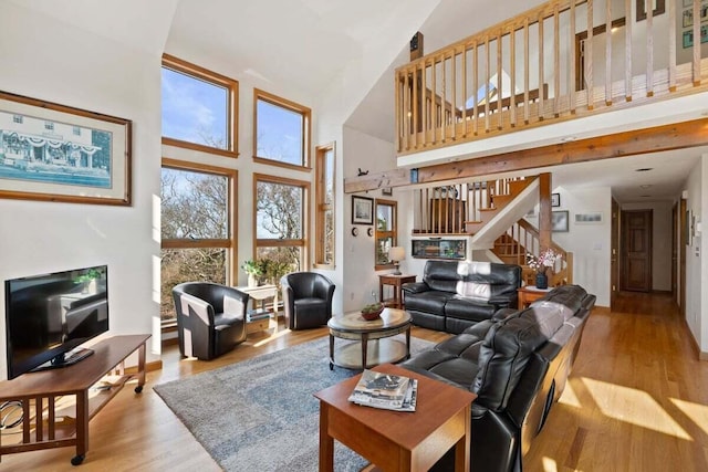 63 Swift Ln, Brewster, MA 02631 - living room with a towering ceiling, stairway, and wood finished floors