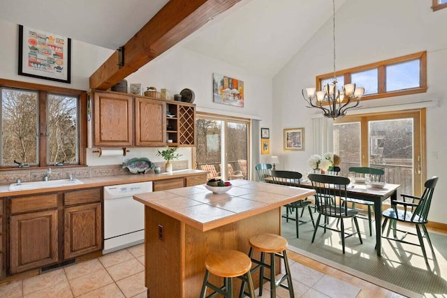 63 Swift Ln, Brewster, MA 02631 - kitchen with dishwasher, tile counters, high vaulted ceiling, light tile patterned floors, and open shelves