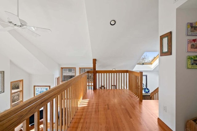63 Swift Ln, Brewster, MA 02631 - hall featuring vaulted ceiling, an upstairs landing, wood finished floors, and a skylight