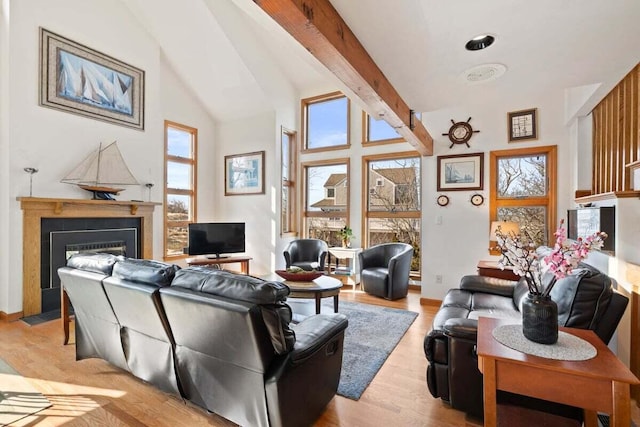 63 Swift Ln, Brewster, MA 02631 - living area with a fireplace with flush hearth, light wood finished floors, high vaulted ceiling, and beam ceiling