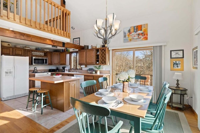63 Swift Ln, Brewster, MA 02631 - dining area with a high ceiling and a chandelier