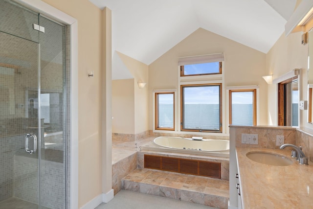 full bathroom with a stall shower, vaulted ceiling, vanity, and a bath