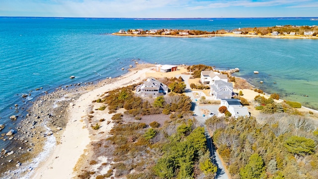 drone / aerial view featuring a beach view and a water view